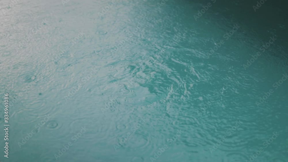 Rain water drops coming down on turquoise bubbling hot springs, Bali Rain water drops coming down on turquoise bubbling hot springs, Bali