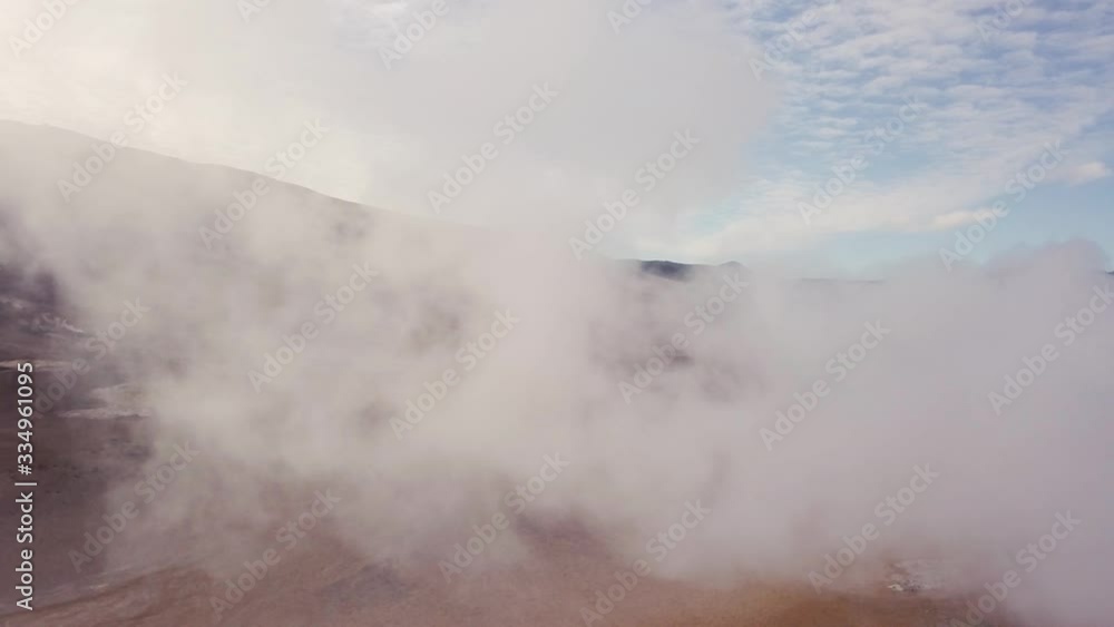 Fly through white smoke backwards reveals blue sky and landscape background, abstract concept Fly through white smoke backwards reveals blue sky and landscape background, abstract concept