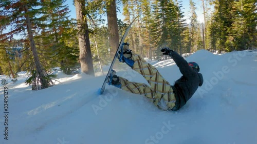 Snowboarder falling in the woods