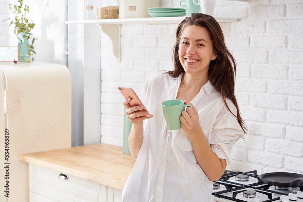 Gorgeous woman drinking water in her kitchen Gorgeous woman drinking water in her kitchen