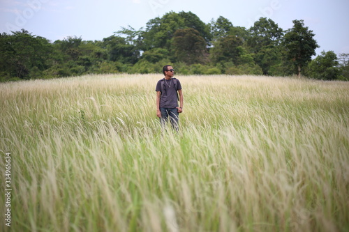 A man standing in grass color white, Thailand