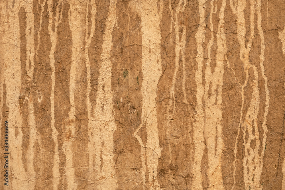 old yellow wall with cracks and peeling white paint. rough surface texture old yellow wall with cracks and peeling white paint. rough surface texture