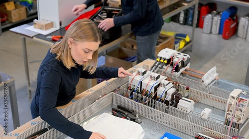 Woman checking cables at batteries