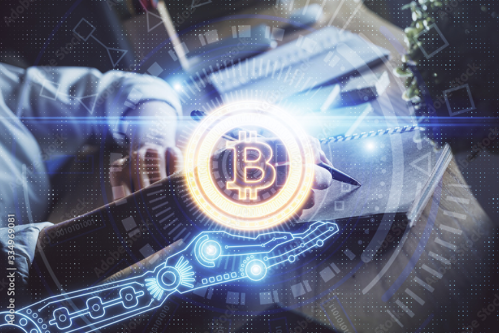 Cryptocurrency hologram, bitcoin, ico theme over hands taking notes background. Concept of blockchain. Multi exposure Cryptocurrency hologram, bitcoin, ico theme over hands taking notes background. Concept of blockchain. Multi exposure