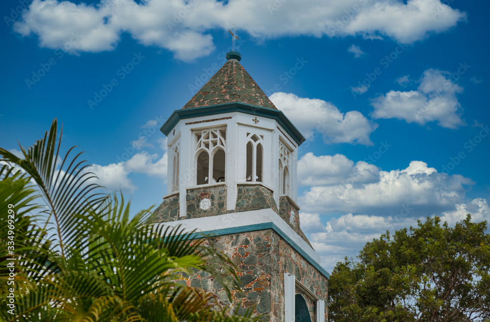 A wood and stone tower on an old church in the tropics