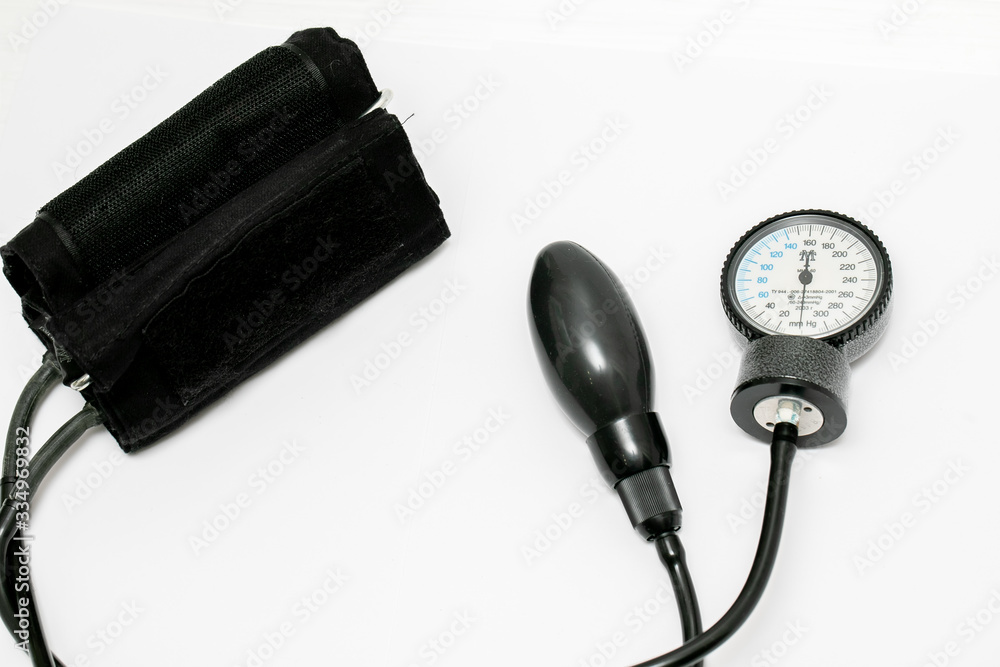 The black tonometer lies on a white background. View from above. Close-up The black tonometer lies on a white background. View from above. Close-up