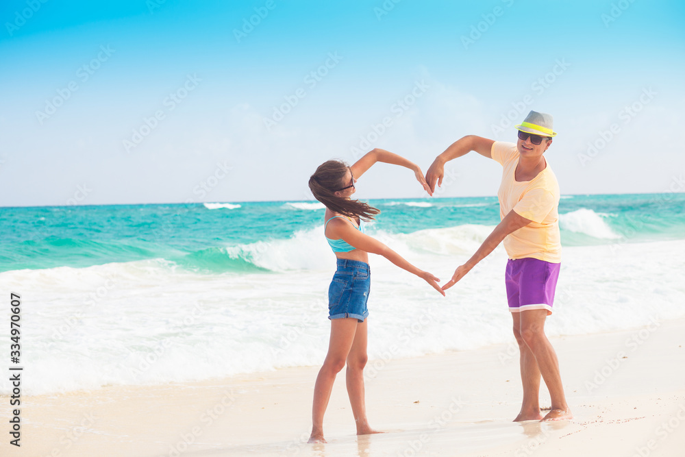 Beach couple walking on romantic travel honeymoon vacation summer holidays romance. Young happy lovers, Cayo Largo, Cuba Beach couple walking on romantic travel honeymoon vacation summer holidays romance. Young happy lovers, Cayo Largo, Cuba