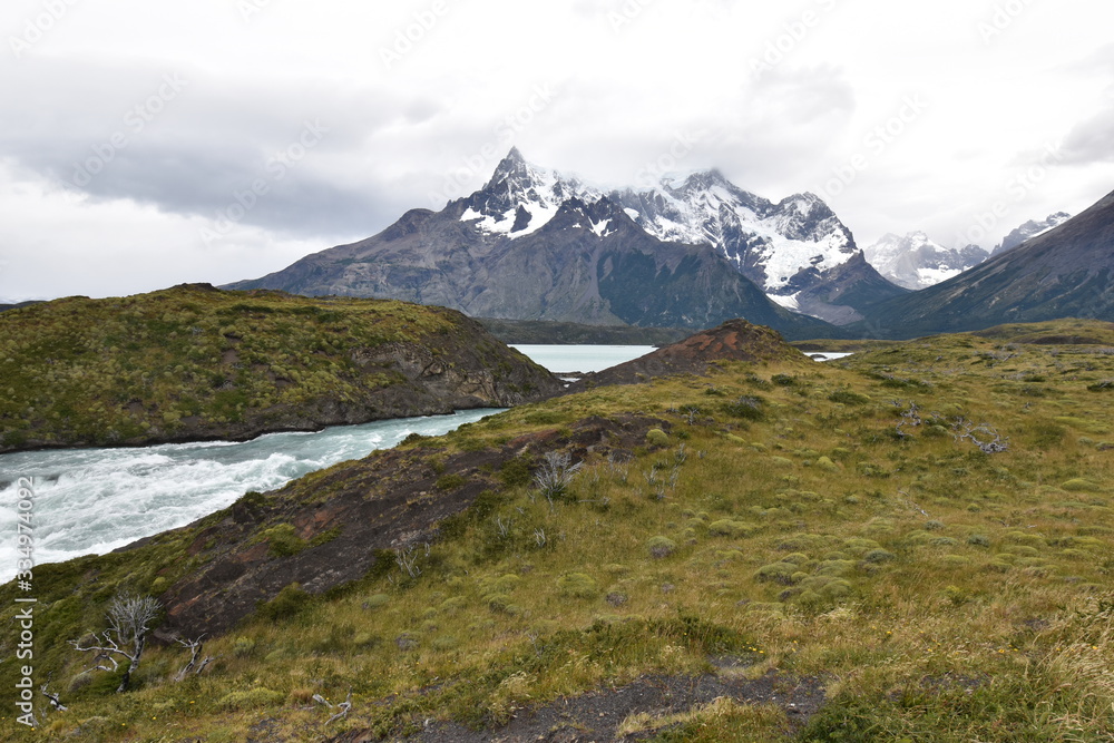 
Snow covered mountains with the light blue ocean in front in Torres del Paine National Park in Chile, Patagonia
