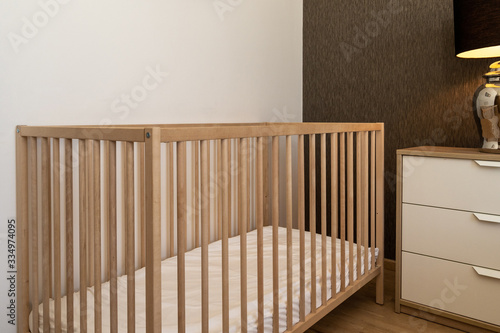Interior design in pool villa, house, home, condo and apartment feature wooden baby cot, baby crib and drawer