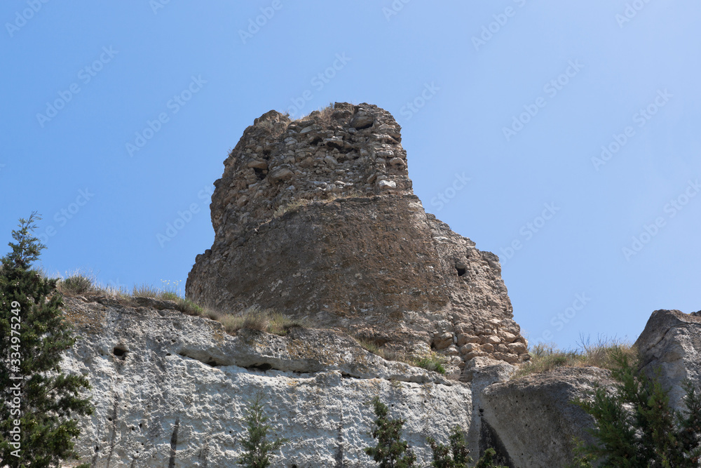 Ruins of the tower of the medieval fortress Calamita in the rock Monastery in Inkerman, Sevastopol, Crimea