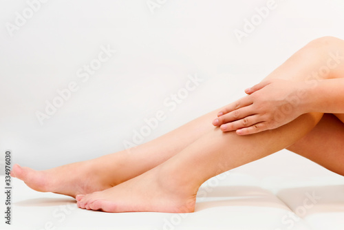 Closeup shot of beautiful female legs and hands. Hair removal concept © giulianocoman