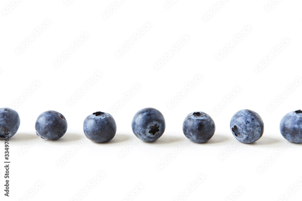 a line of blueberries on white background a line of blueberries on white background