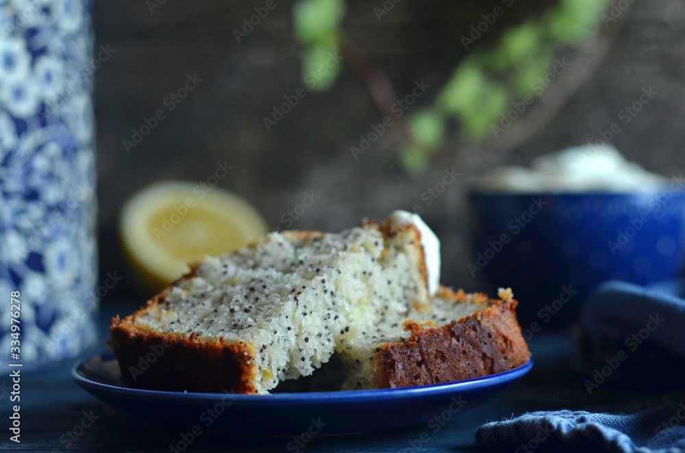 Pieces of lemon cake with poppy seeds on a saucer on a blue background Pieces of lemon cake with poppy seeds on a saucer on a blue background