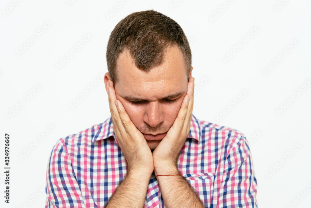 Young businessman holding head in his hands Young businessman holding head in his hands