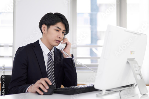 パソコン作業をしながら考え込む日本人男性ビジネスマン Stock Photo Adobe Stock パソコン作業をしながら考え込む日本人男性ビジネスマン Stock Photo Adobe Stock