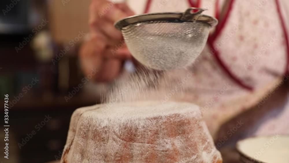 Sprinkling sugar on top of a traditional Slovenian dessert called Potica