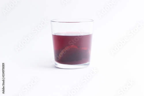 Compote made of dry apple slices and black currant on white background