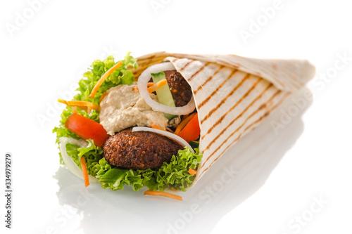 vegetarian tortilla wrap with falafel and hummus, isolated on white background