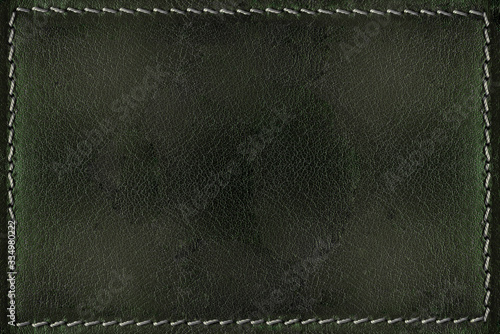 Green leather background with seams