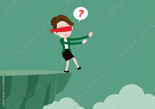 Blindfolded businesswoman is walking towards a cliff