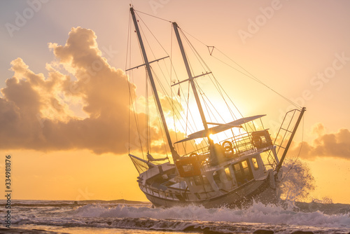 Fototapeta Sailing boat wreck at sunset