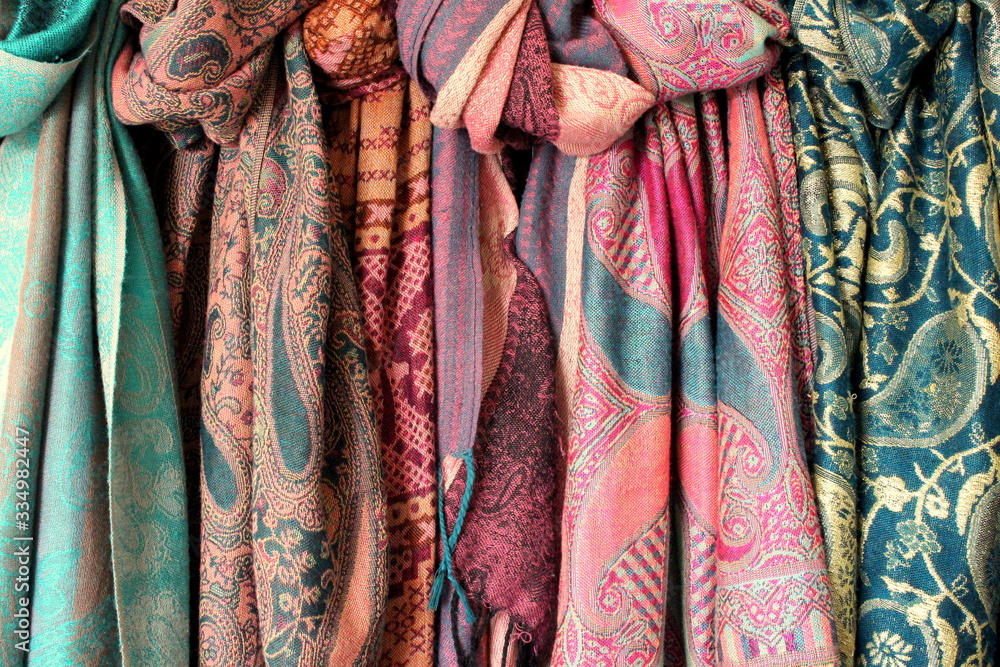 A photograph of a bundle of colorful scarves.  Women's fashion. 
