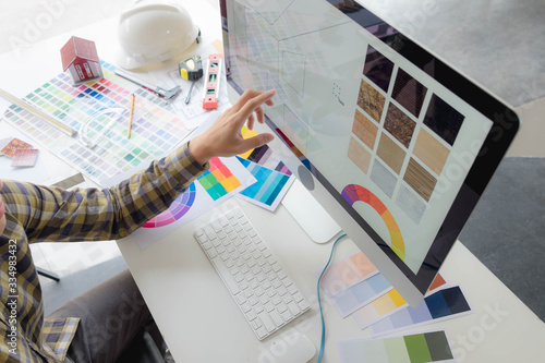 Engineers and creative artists work on table, work, consult, advise on choosing colors and materials, measuring size, choosing cool colors, soft tones, beautiful tones.
