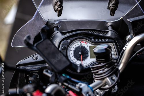 Motorcycle details close up. Motorbike speedometer, warning lights, mobile device holder. Close up, selective focus © CrunchyBeans