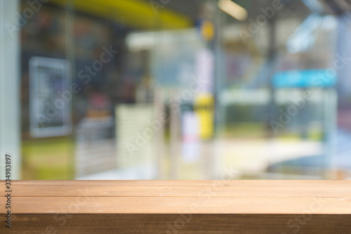 Empty tropical wood table and blurred garden cafe light background. product display template.Business presentation