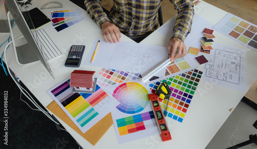 Engineers and creative artists work on table, work, consult, advise on choosing colors and materials, measuring size, choosing cool colors, soft tones, beautiful tones.