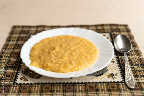 Yellow pea puree in a white plate