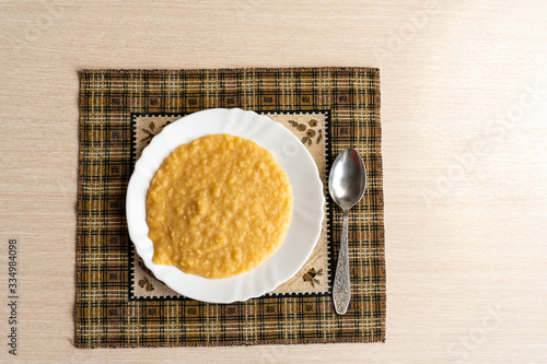 Yellow pea puree in a white plate