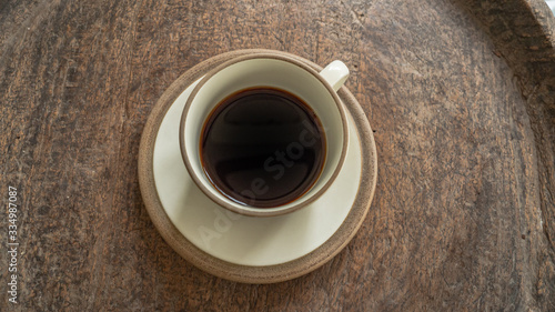 black coffee on wooden table. ceramic round cup. background