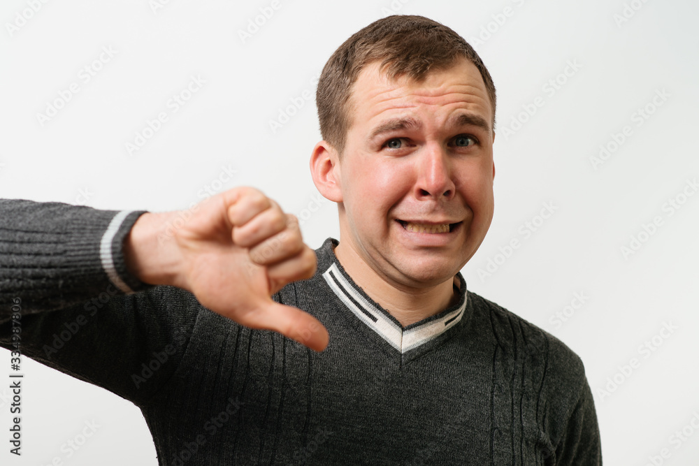 man showing a thumb down gesture man showing a thumb down gesture