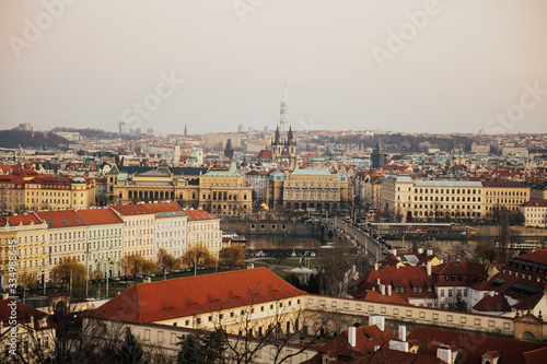 Rooftop view over historical center of Prague, Czech republic, EU. Tyn Church and Prague Castle. Red roofs and spires of historical Old Town of Prague. Copy space.
