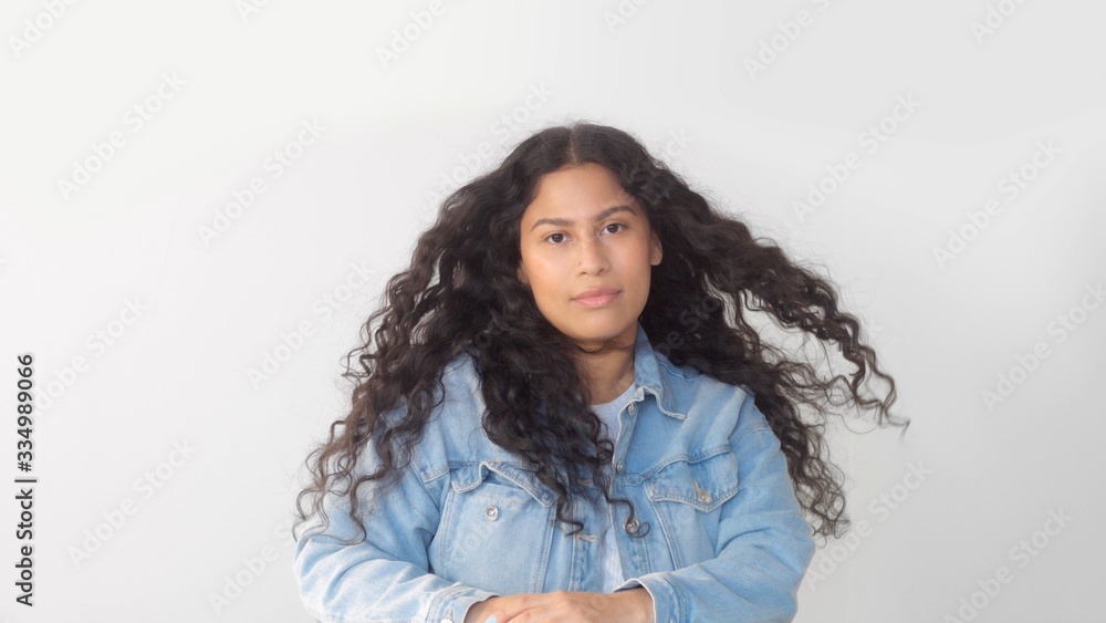 Mixed race plus size woman without makeup in studio watching to the camera and touch her face Mixed race plus size woman without makeup in studio watching to the camera and touch her face