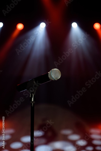 Close-up of microphone at concert against blur colorful light background