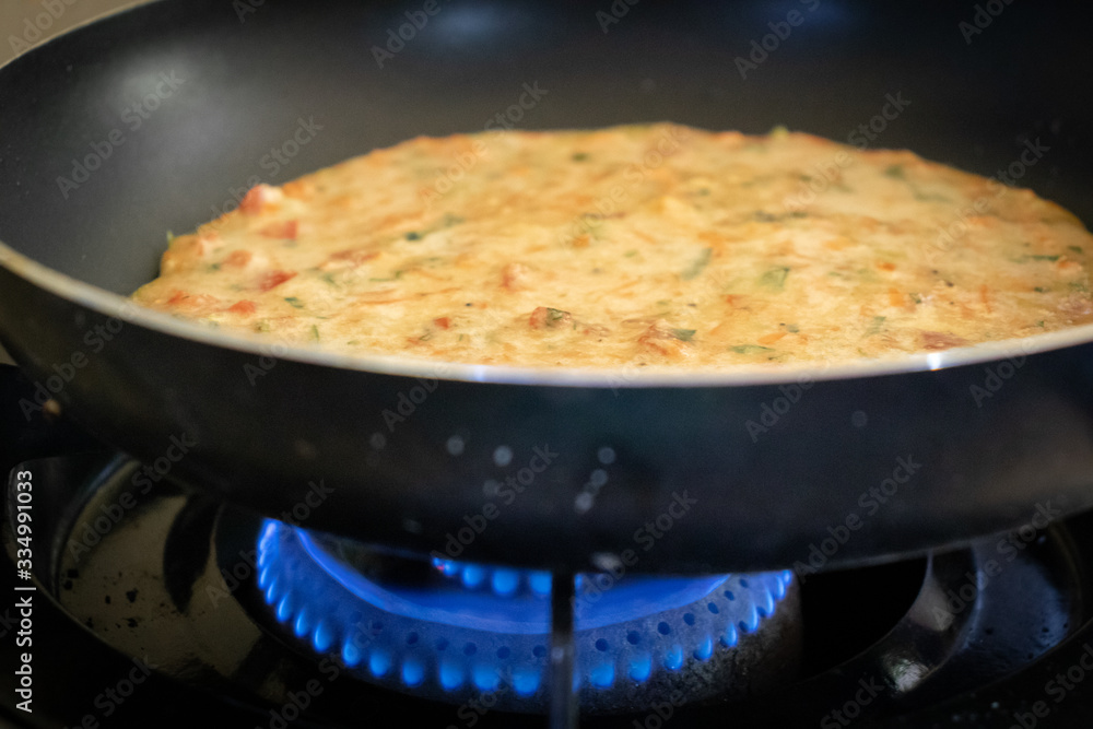 easy Egg-Oats omelette cooking on a pan easy Egg-Oats omelette cooking on a pan