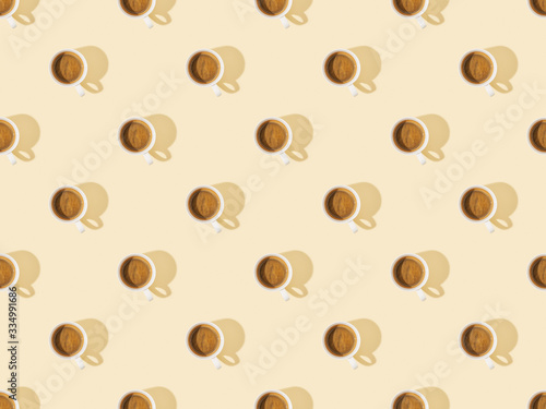 top view of cups of fresh coffee on beige, seamless background pattern