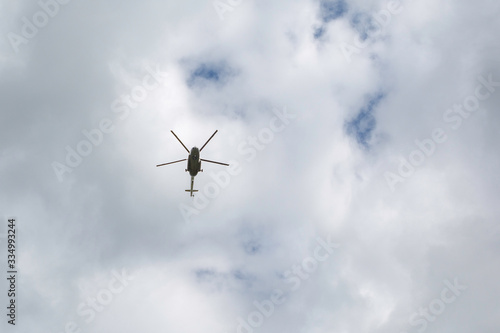 helicopter in flight against a cloudy sky