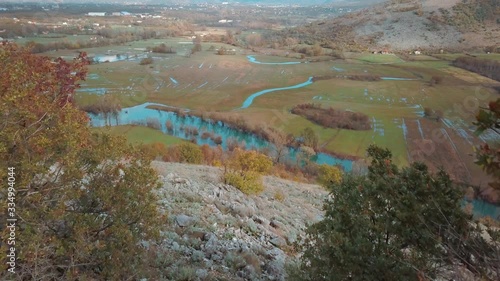  A River in a Marshy Area in Autumn. River Matica Landscape. Aerial Footage of a Swampy River and Green Flooded Fields From a Bird's Eye View. Rijeka Matica i Okolina u Jesenjim Bojama. photo