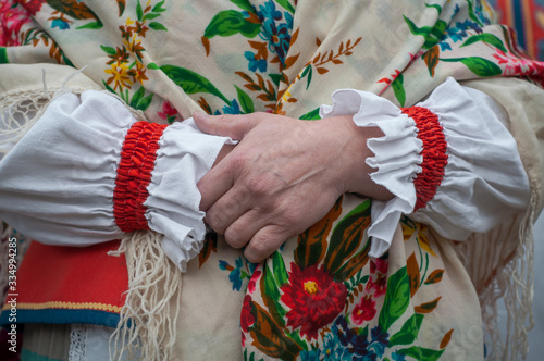 Beautiful woman hands in traditional folk Belarusian.clothes. Traditional autumn harvest festival. People and traditions.