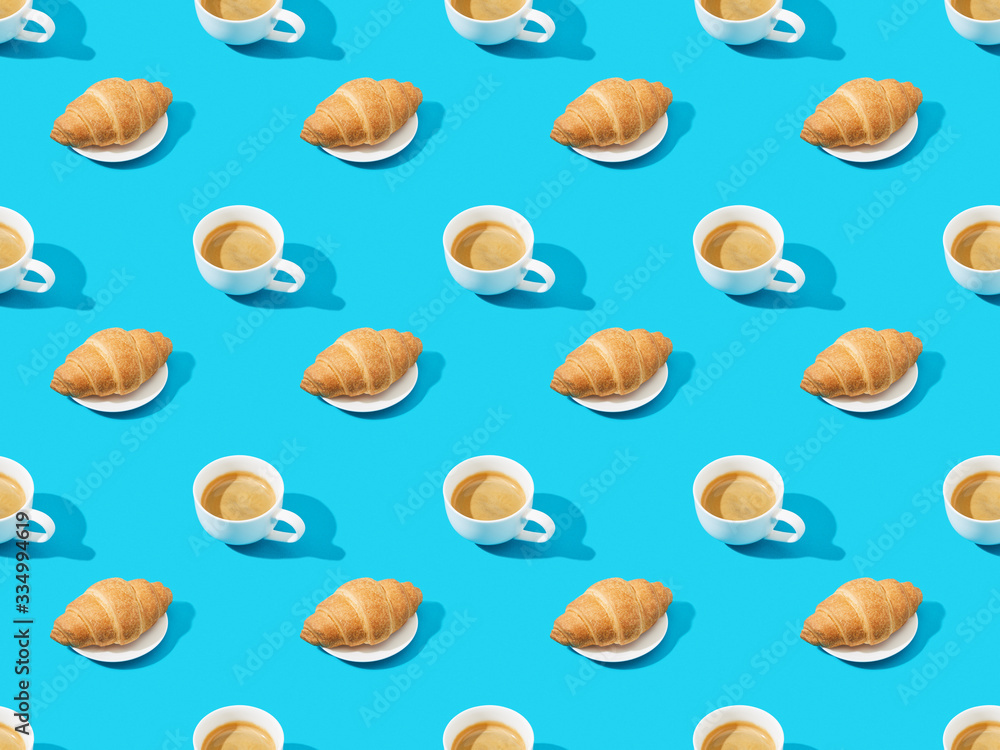 fresh croissants on plates and coffee on blue, seamless background pattern fresh croissants on plates and coffee on blue, seamless background pattern