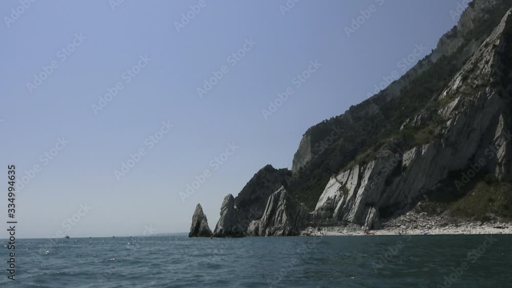 Italy, Marche, Ancona, Cost of the Conero,The Two Sisters rocks, rocks white that rise out of the sea,shooting from the boat into the sea,blue sky, blue sea Italy, Marche, Ancona, Cost of the Conero,The Two Sisters rocks, rocks white that rise out of the sea,shooting from the boat into the sea,blue sky, blue sea