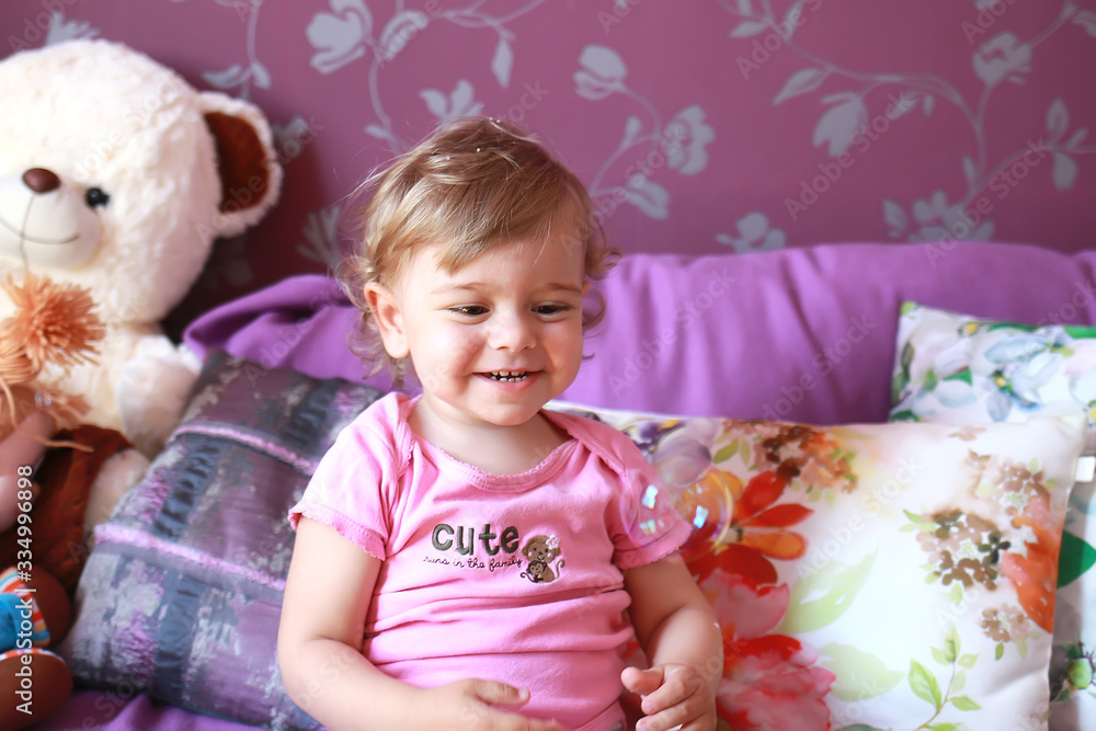 little cute caucasian girl plays in her room with soap bubbles. Children's emotions, smile and laughter. Close-up. little cute caucasian girl plays in her room with soap bubbles. Children's emotions, smile and laughter. Close-up.