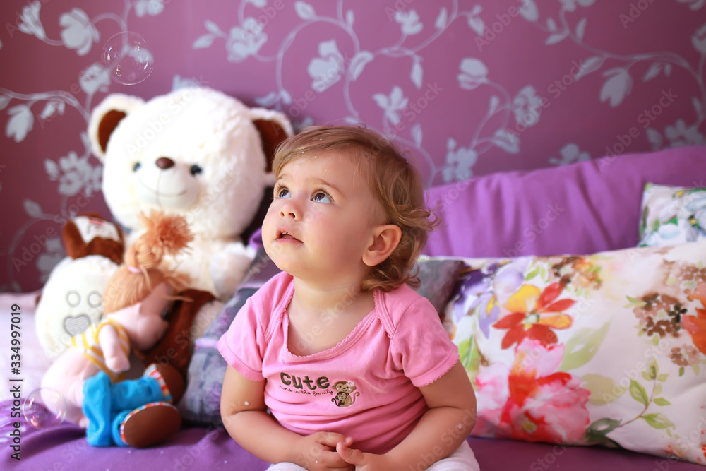 little cute caucasian girl plays in her room with soap bubbles. Children's emotions, smile and laughter. Close-up. little cute caucasian girl plays in her room with soap bubbles. Children's emotions, smile and laughter. Close-up.