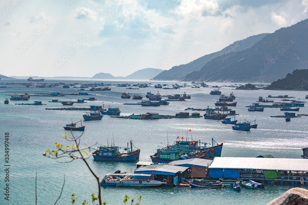 Fishing boats and freight ships in a bay in Vietnam