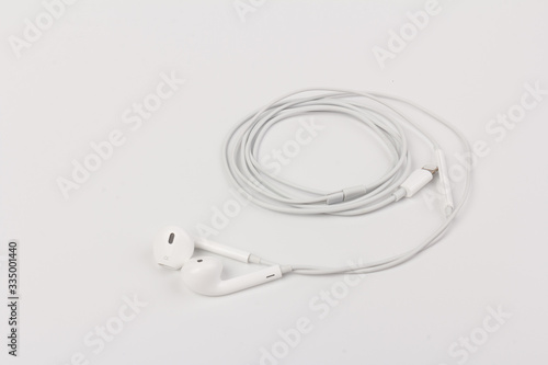 White headphones for listening to music and sound on portable devices: music player, smartphone, laptop and jack for connection on a white background. © Olga