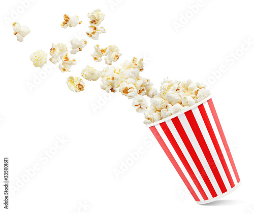 Popcorn flying out of red-white striped paper cup, isolated on white background