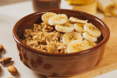 Oatmeal porridge with banana and almonds, healthy and nutrititious breakfast. 